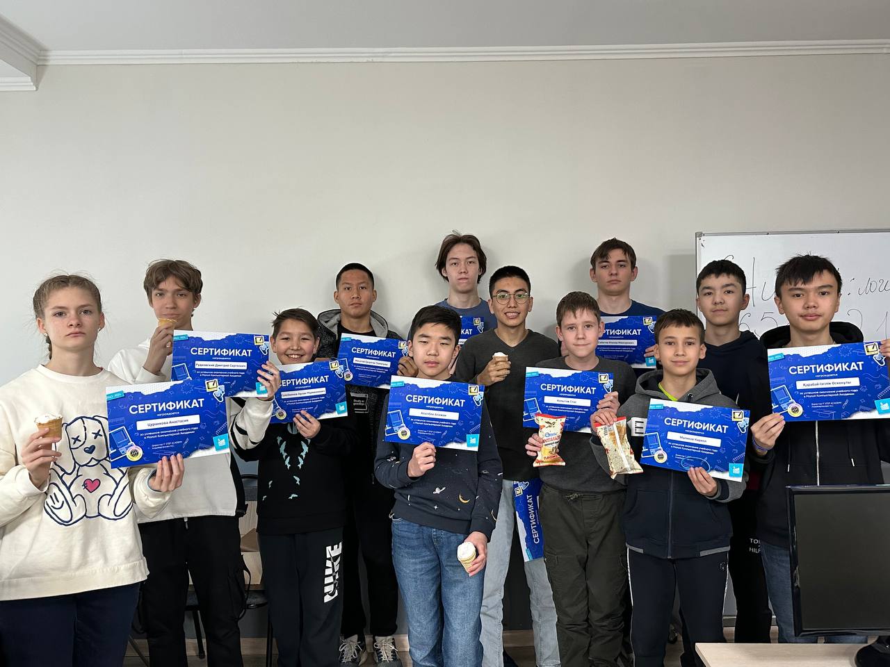 Students holding certificates at ITSTEP Academy