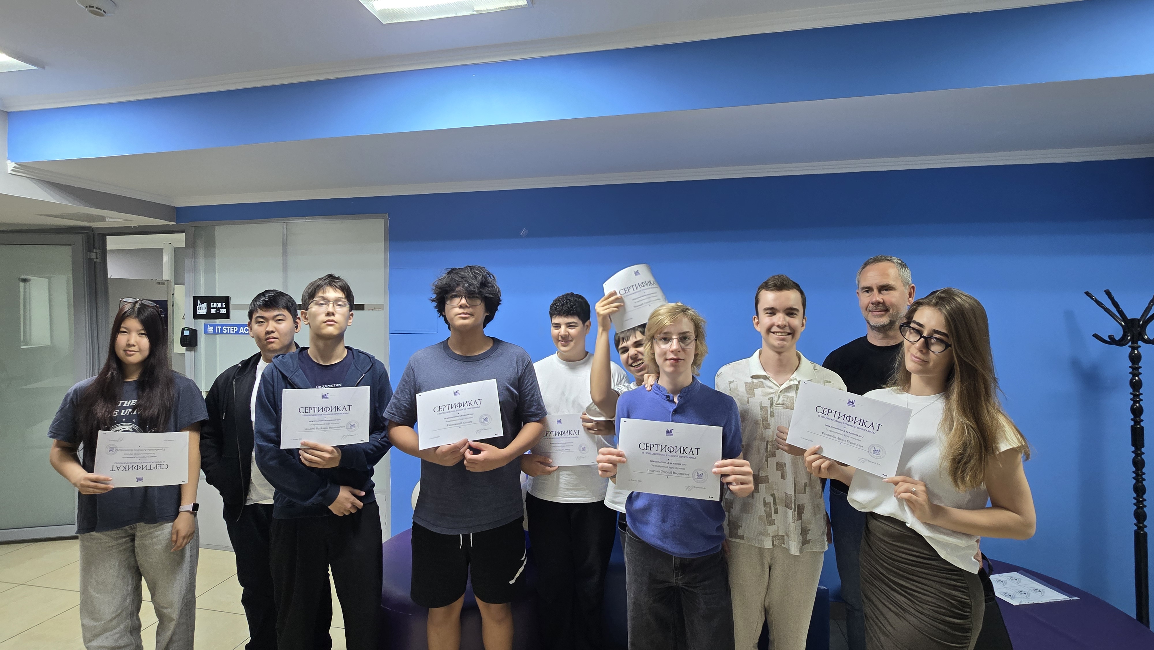 Students holding certificates at ITSTEP Academy