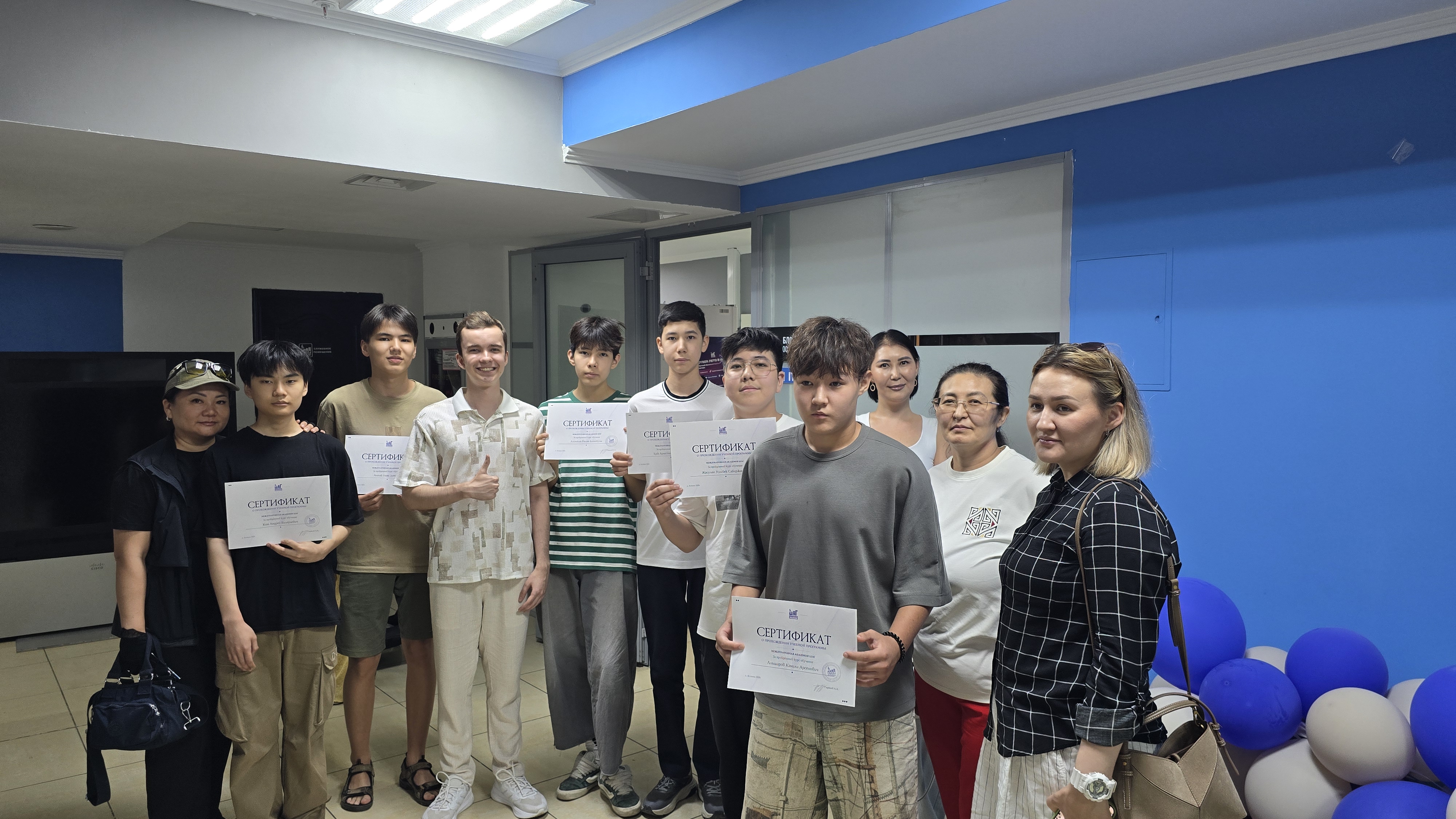 Students holding certificates at ITSTEP Academy