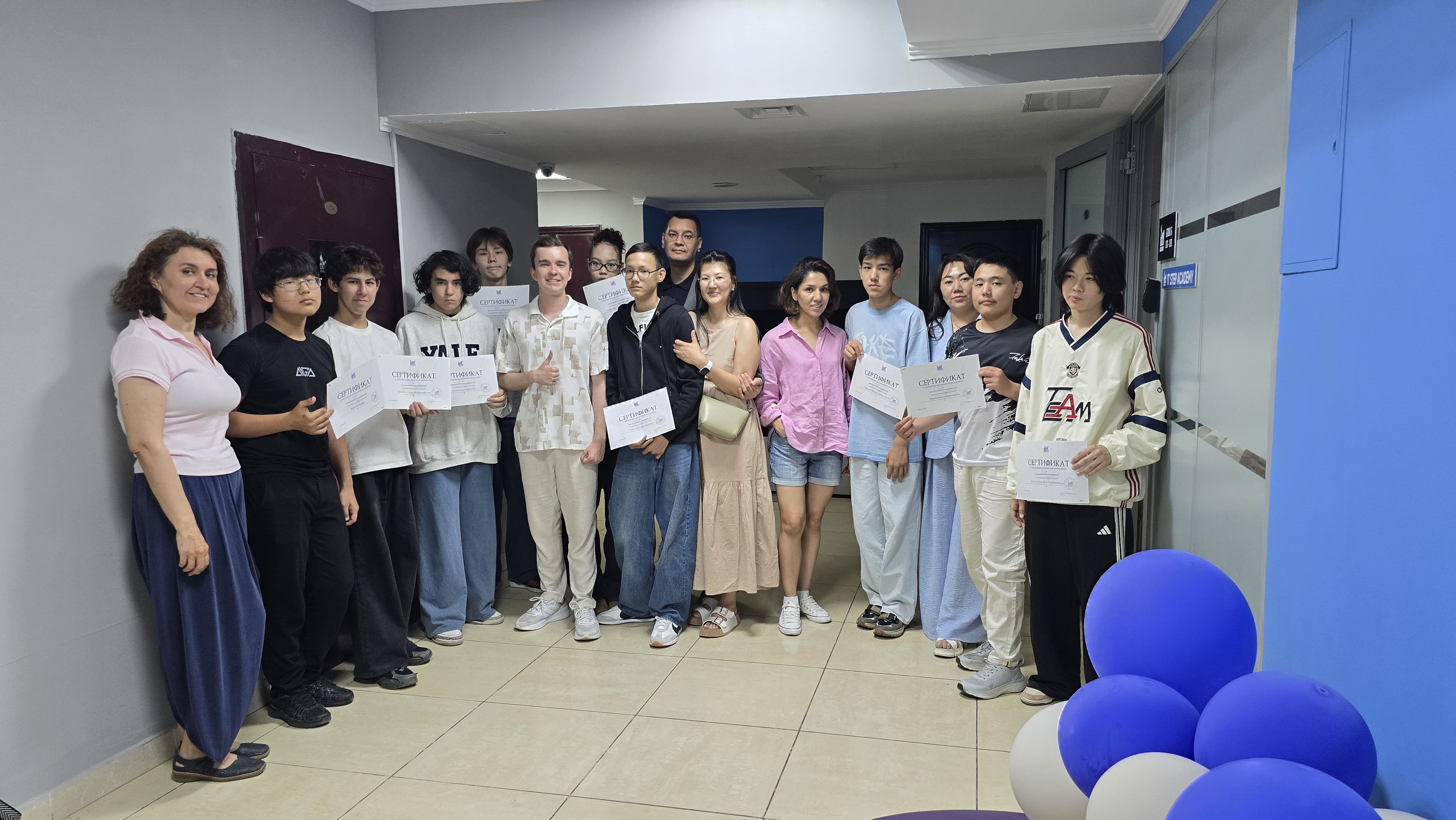 Students holding certificates at ITSTEP Academy